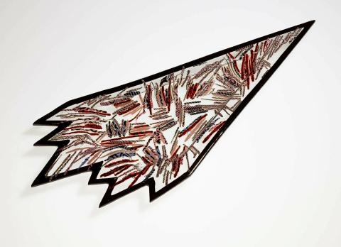 Artwork Slumped dish this artwork made of Red, black, blue, pink and grey coloured canes of glass set in clear glass and slumped into an irregular arrow shape, created in 1985-01-01