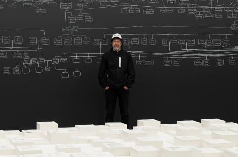 An artist stands with his room-scale installation work at the Australia Pavillion of the Venice Biennale
