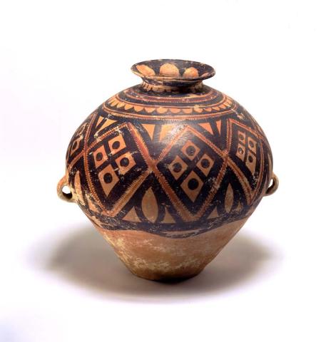 Artwork Storage jar (kuan) this artwork made of Swelling earthenware shape, narrowing to the base, with flared mouth and two lugs set vertically at the maximum diameter, painted with black and maroon pigments in a band of large diamond shaped motifs below a narrow band of wave crest pattern repeated on the neck and inside the mouth