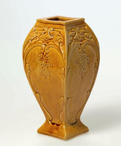 Artwork Slab vase this artwork made of Earthenware, slab built tapering square body carved with scrolls and pendant flowers, ochre glaze, created in 1944-01-01