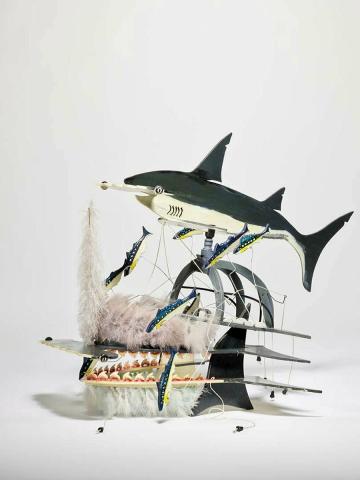 Artwork Beizam headdress (Shark with bait fish) this artwork made of Plywood, enamel paint, wire, feathers (chicken), shark's teeth (tiger shark), string, created in 1995-01-01
