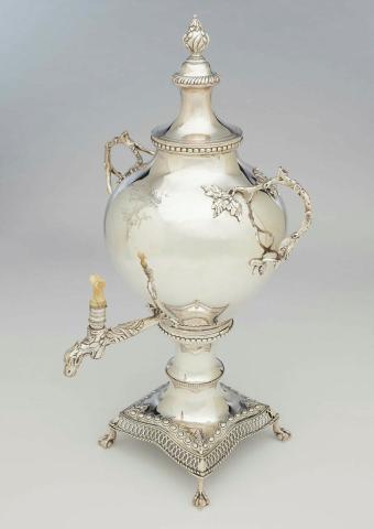 Artwork Tea urn this artwork made of Silver, the swelling body decorated in a modified rococo style with branch handles and foliage. The stand with pierced edge and with cast bird feet. Engraved with heraldic crest, created in 1770-01-01