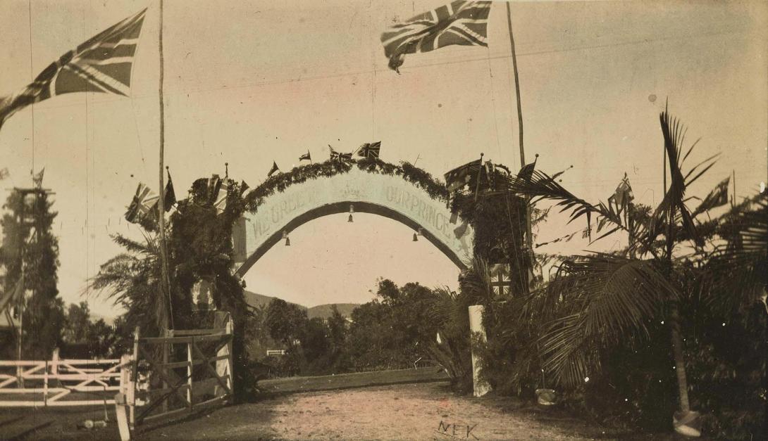 Artwork Processional Arch 'We Greet Our Prince' this artwork made of Gelatin silver photograph, hand-coloured on paper mounted on card, created in 1896-01-01