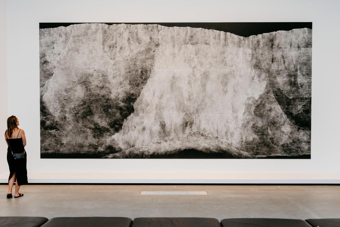 A large work made in chalk on blackboard installed in a bright gallery space.