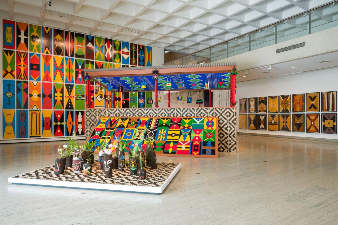 A photograph of colourful artworks installed in a large gallery space