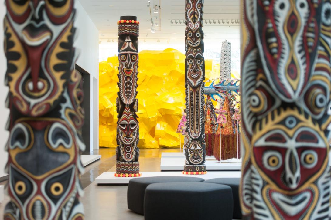 Papua New Guinean carved poles installed in a gallery space