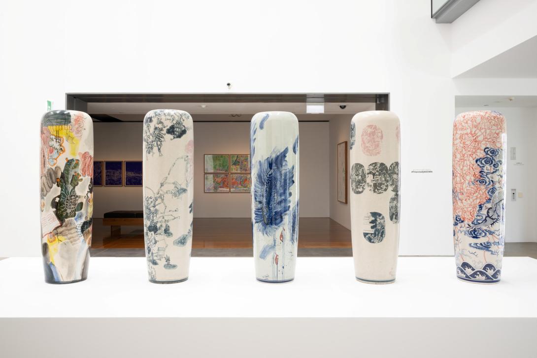 Vases installed on a plinth in a brightly lit gallery space