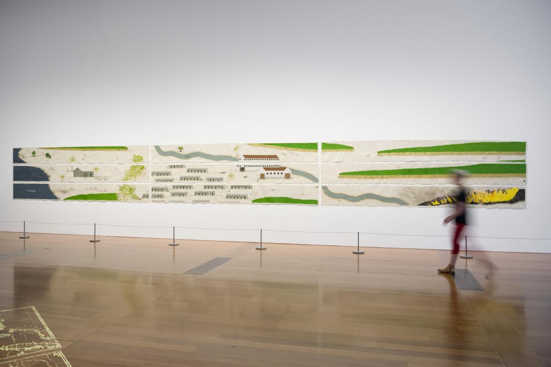 A long, large-scale work on wasli paper installed on a white gallery wall