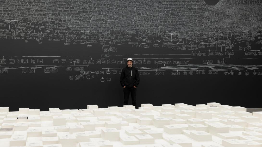 An artist stands with his room-scale installation work at the Australia Pavillion of the Venice Biennale