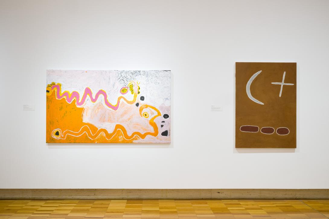Two paintings installed on a white wall in a gallery space