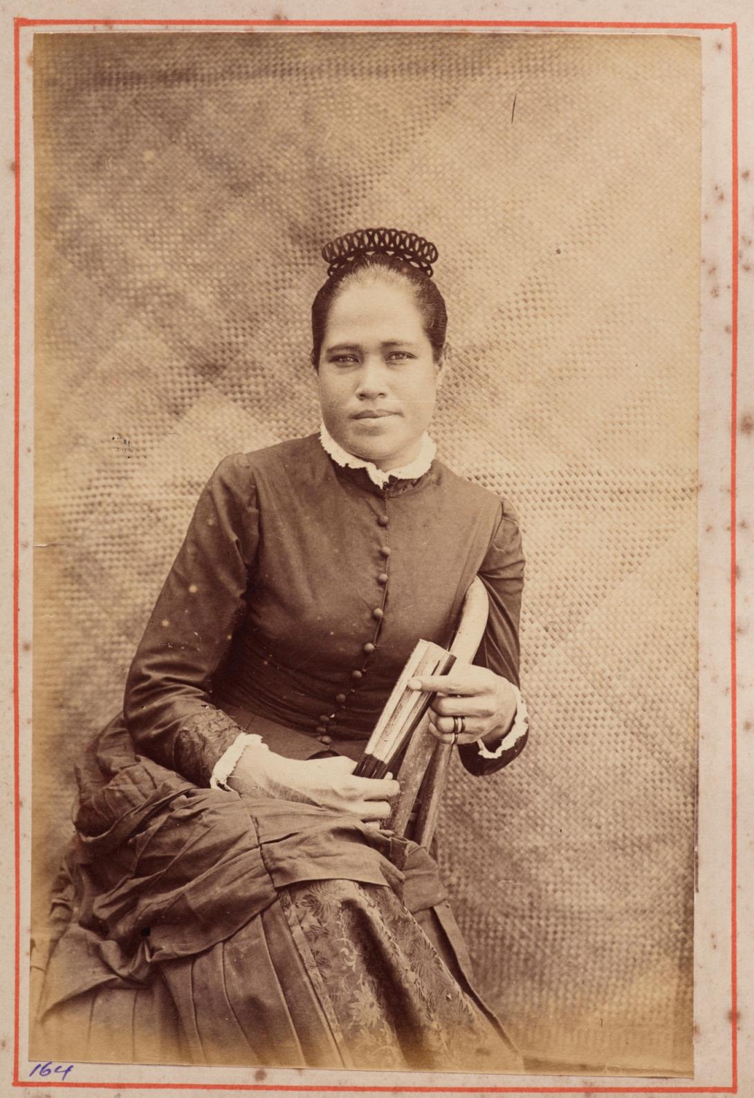 A black-and-white photograph from 1886 of a Samoan woman in Western dress