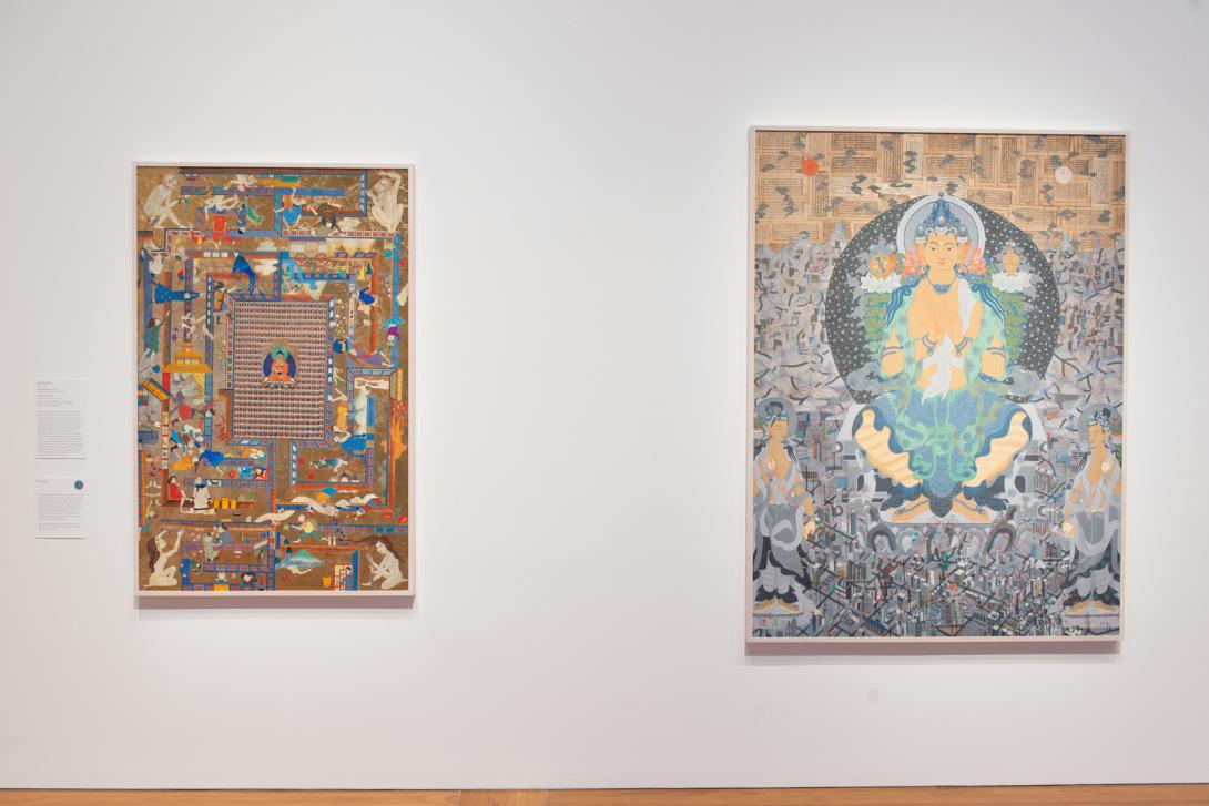 Two Mongol Zurag paintings installed on a white wall in a bright gallery space