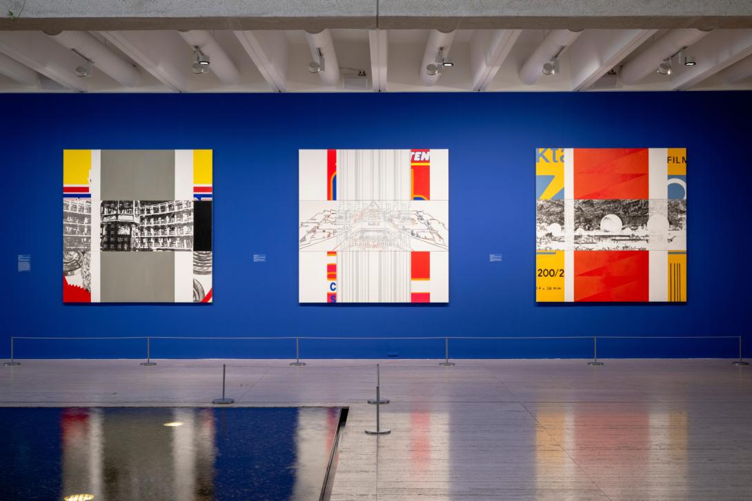A gallery display of three large, colourful, square-shaped paintings installed on a bright cobalt-coloured wall, with a pool of water in the foreground. Works by Richard Dunn on display in the QAG Watermall, March 2026 / © Richard Dunn / Photograph: J Ruckli, QAGOMA 