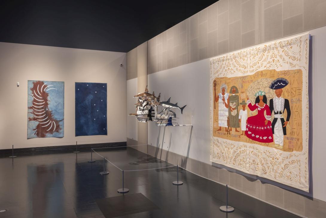 Brightly coloured paintings and sculptures installed in a gallery space