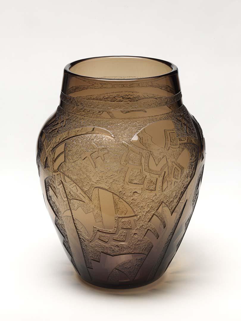 Artwork Vase this artwork made of Mould blown smokey grey glass of oval form deeply acid-etched with a design of abstracted tulips and leaves and cross hatches.  Fire polished, created in 1920-01-01