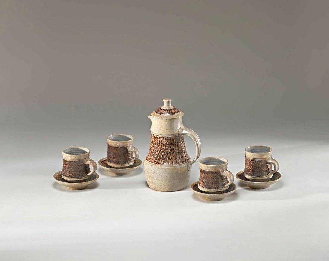 Artwork Coffeepot and four cups and saucers this artwork made of Stoneware, thrown waisted forms with chattered band brushed manganese and salt glazed, created in 1962-01-01