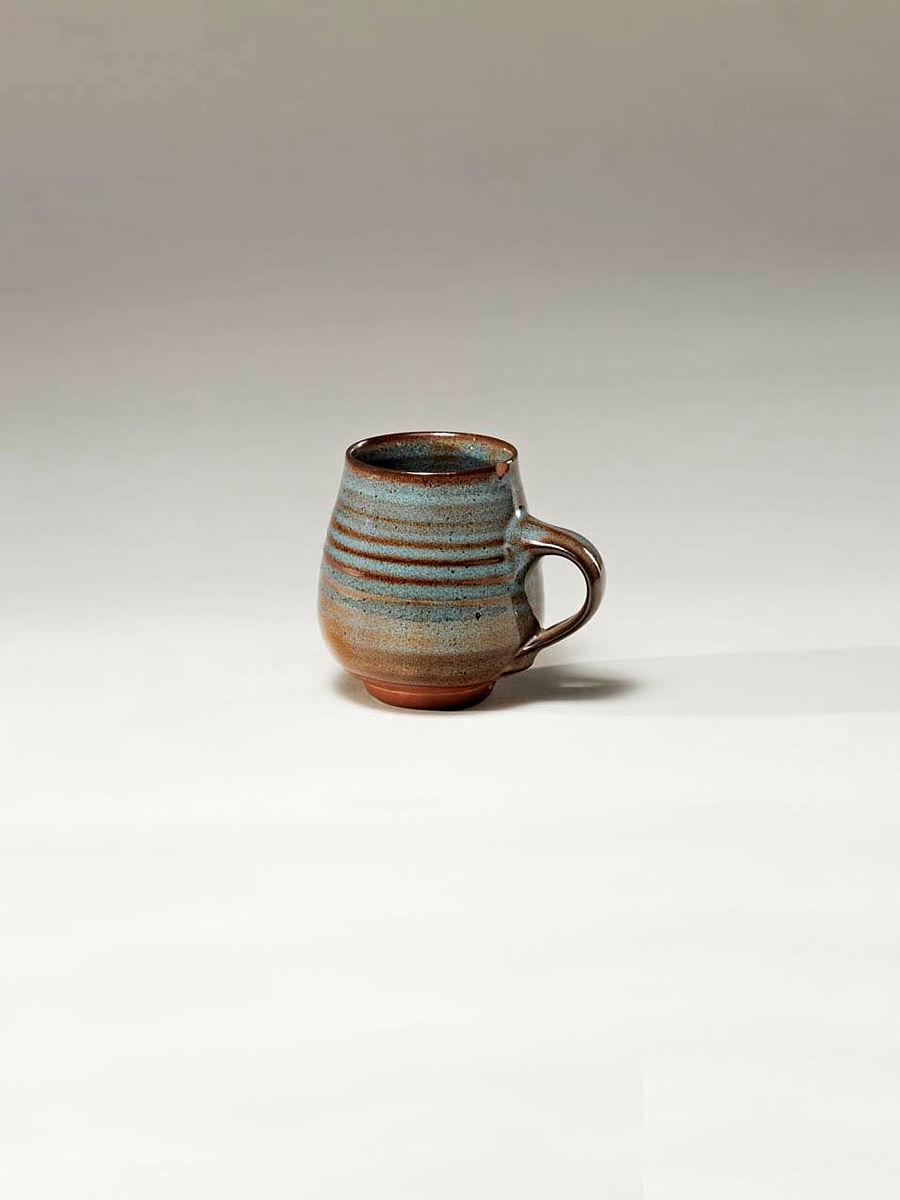 Artwork Cup this artwork made of Earthenware clay from Pinjarra Pottery fired to stoneware temperatures (vitri fired). Blue glaze, created in 1967-01-01