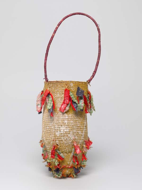 Artwork Dilly bag this artwork made of Twined pandanus (Pandanus spiralis) fibre, natural pigments, feathers, cotton fabric and coiled pandanus fibre handle, created in 1997-01-01