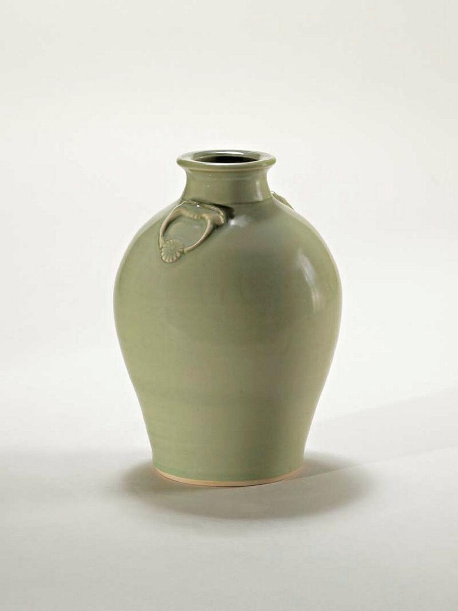 Artwork Bottle this artwork made of Porcelain, wheelthrown with dragon's head masks and pendant ring and chrysanthemum decoration beneath celadon glaze