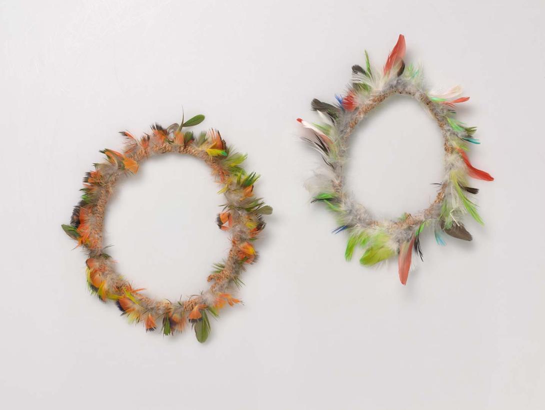 Artwork Ceremonial armbands (dhuwa) this artwork made of Bark fibre string with red-winged parrot and red-collared lorikeet feathers, created in 1996-01-01