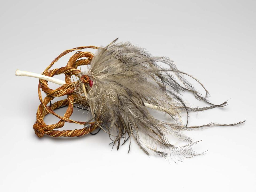 Artwork Bush fascinator I this artwork made of Twined spinifex (Triodia pungens), seed, emu bone, emu feathers, spinifex resin and wax thread, created in 2011-01-01