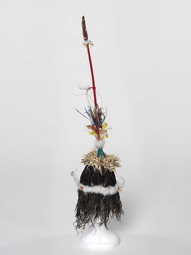 Artwork Ralavon this artwork made of Tokatokoi headdress: shredded sago fibres, dyes, wool, feathers, dried fern over split cane armature and stick, created in 2011-01-01