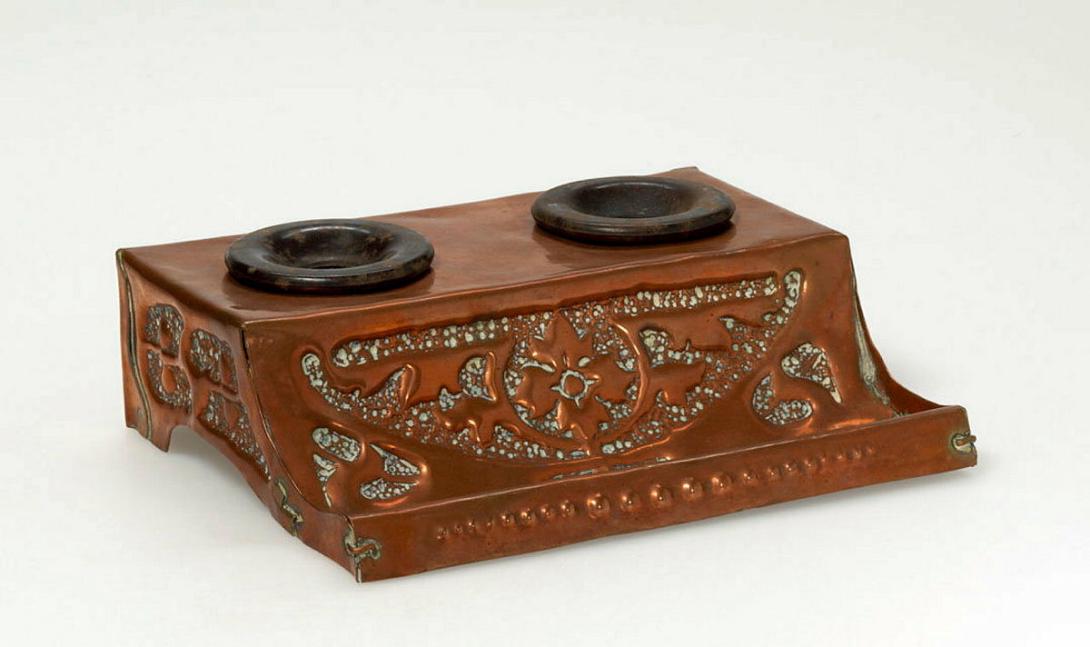 Artwork Inkwells this artwork made of Copper repoussé with inset Bakelite inkwells, created in 1910-01-01