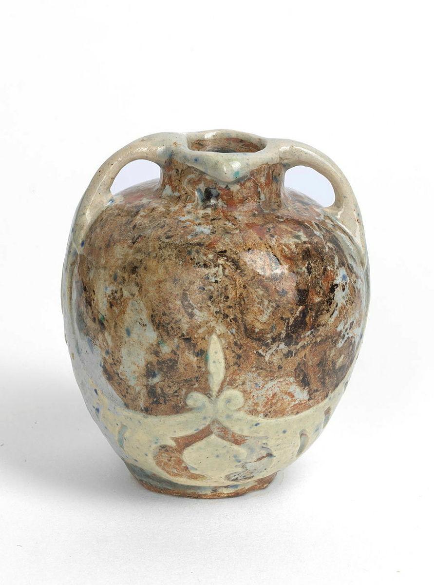 Artwork Miniature pot with two handles this artwork made of Earthenware, hand built, mixed clay dipped cream slip and carved beneath handles. Clear glaze, created in 1919-01-01