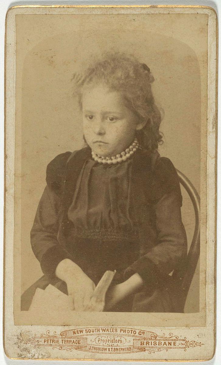 Artwork (Young girl in black dress) this artwork made of Albumen photograph on paper mounted on card, created in 1885-01-01