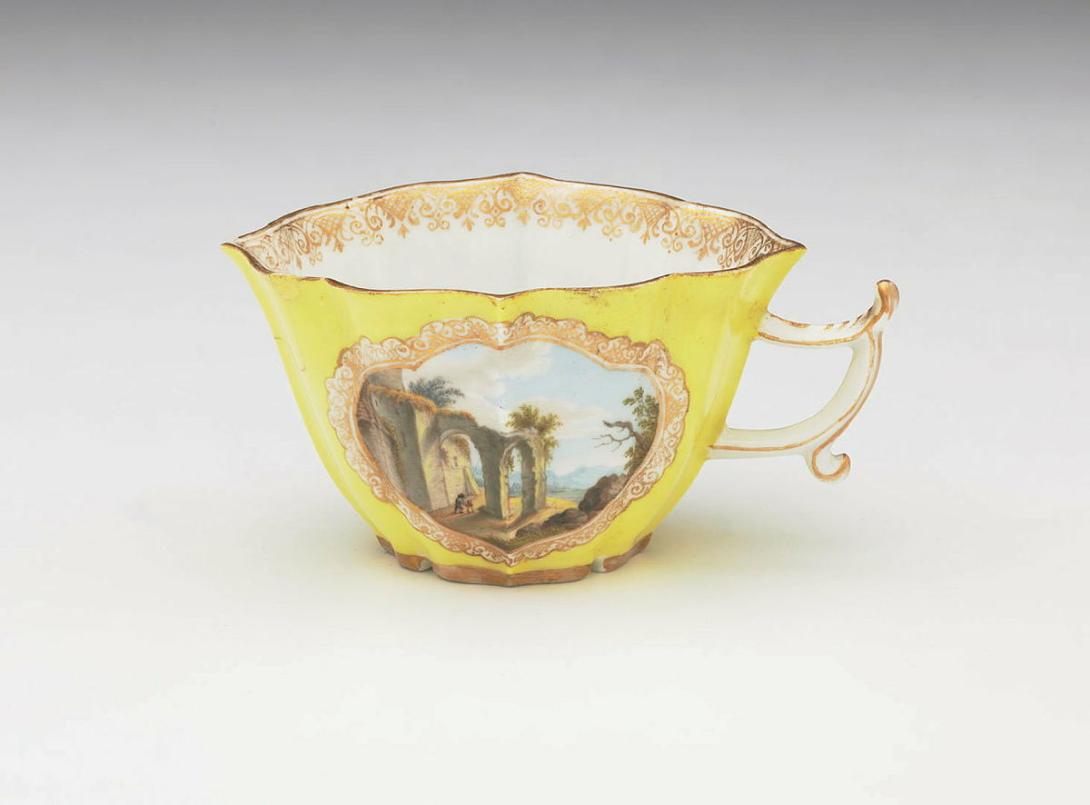 Artwork Cup and saucer (fluted) this artwork made of Hard-paste porcelain decorated with a mountain scene with ruined castles in overglaze colours against a yellow ground, created in 1800-01-01