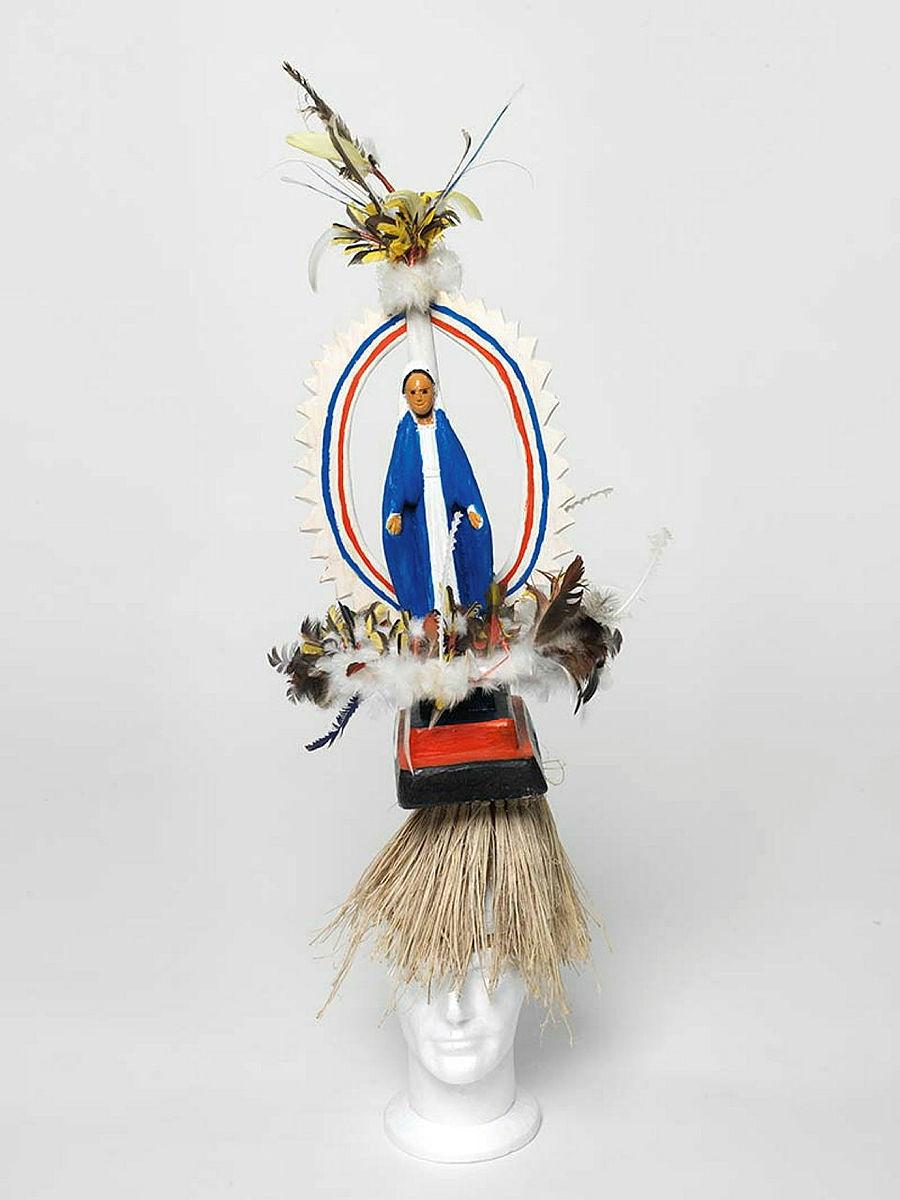 Artwork Mary this artwork made of Tokatokoi, headdress: wood, feathers, plastic Virgin Mary figurine, synthetic polymer paint, grass fibre, created in 2011-01-01