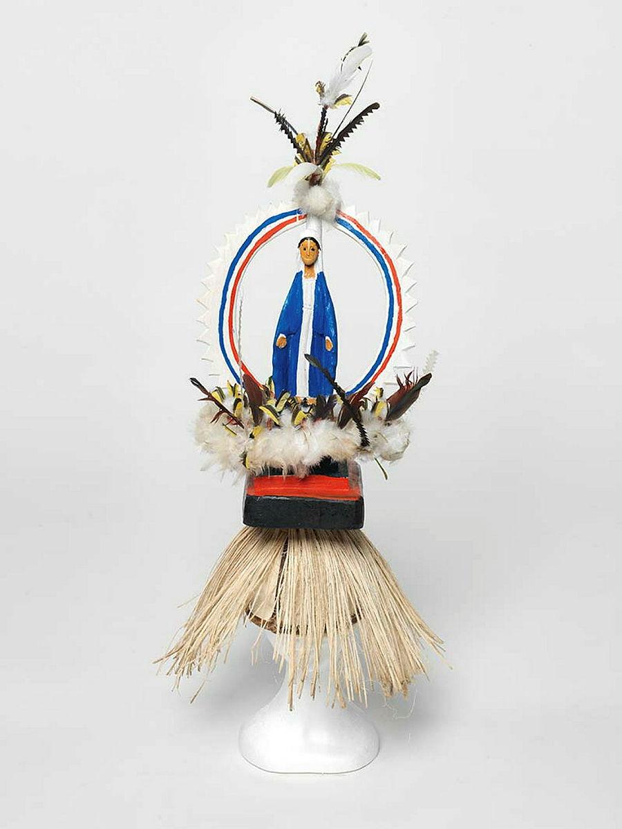 Artwork Mary this artwork made of Tokatokoi, headdress: wood, feathers, plastic Virgin Mary figurine, synthetic polymer paint, grass fibre, created in 2011-01-01