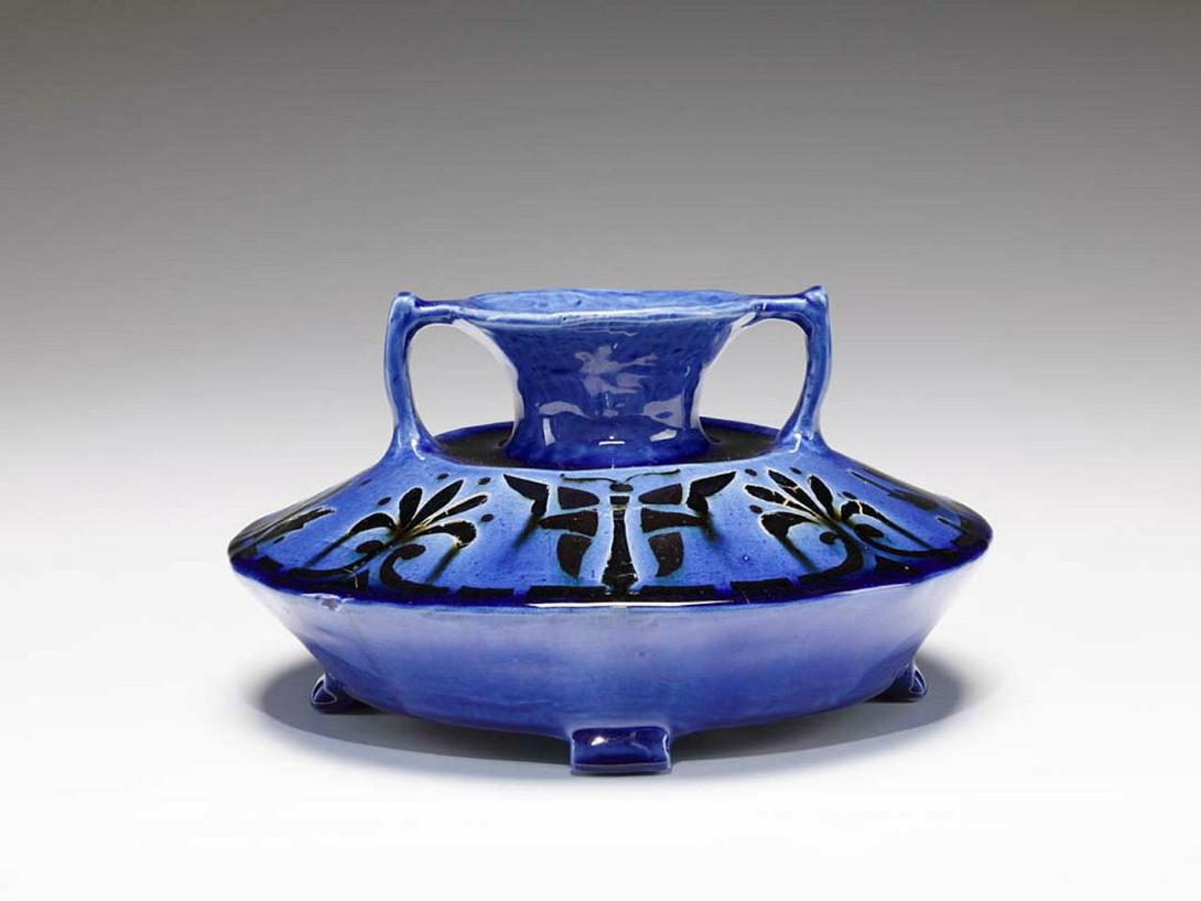 Artwork Inlaid vase this artwork made of Earthenware slab and hand built, inlaid on the top surface with a design of palmetts and moth motifs in stained clay.  Glazed cobalt blue, created in 1930-01-01