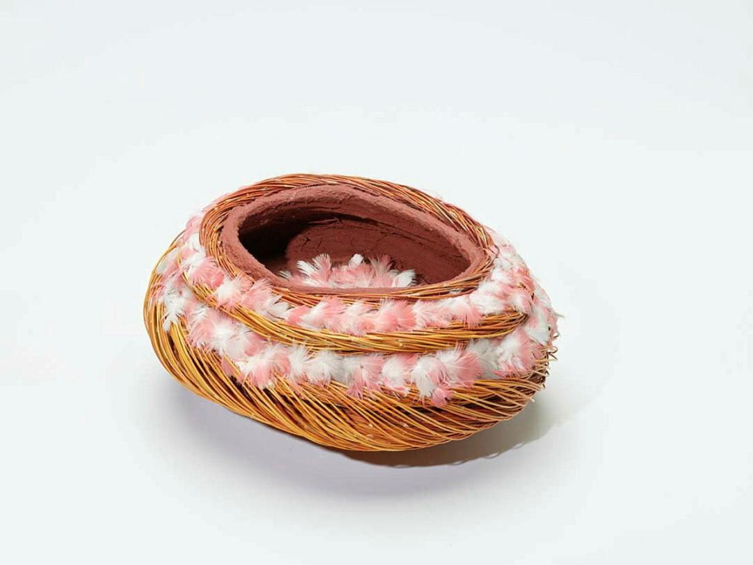 Artwork Erkel (vessel) this artwork made of Twined spinifex (Triodia pungens), red ochre, galah feathers, nylon thread and synthetic polymer fixative, created in 2010-01-01