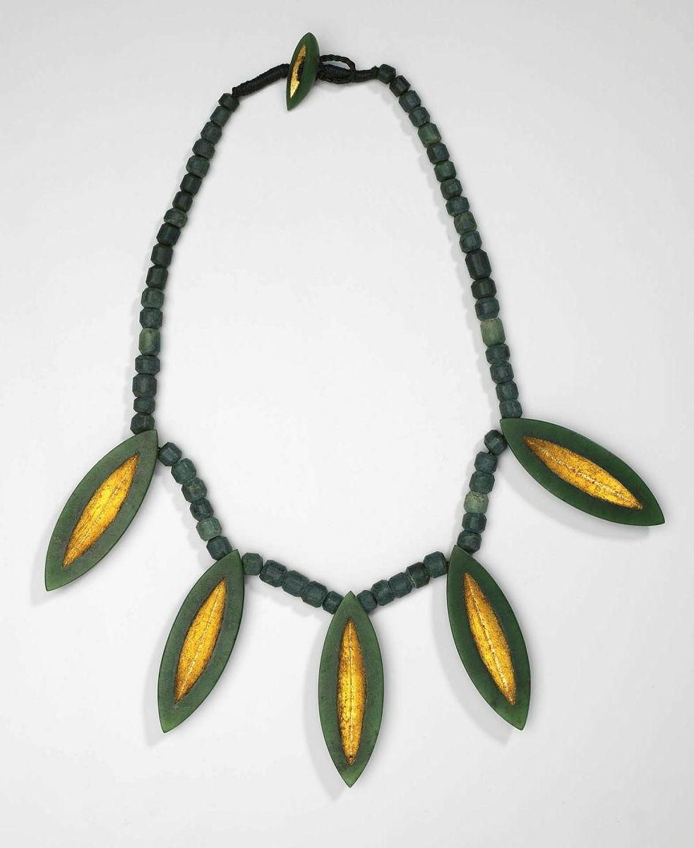 Artwork Nga Waka (necklace) this artwork made of Jade (from Cascade River, South Westland) and gold leaf on braided nylon cord with Pounamu bead, created in 1966-01-01