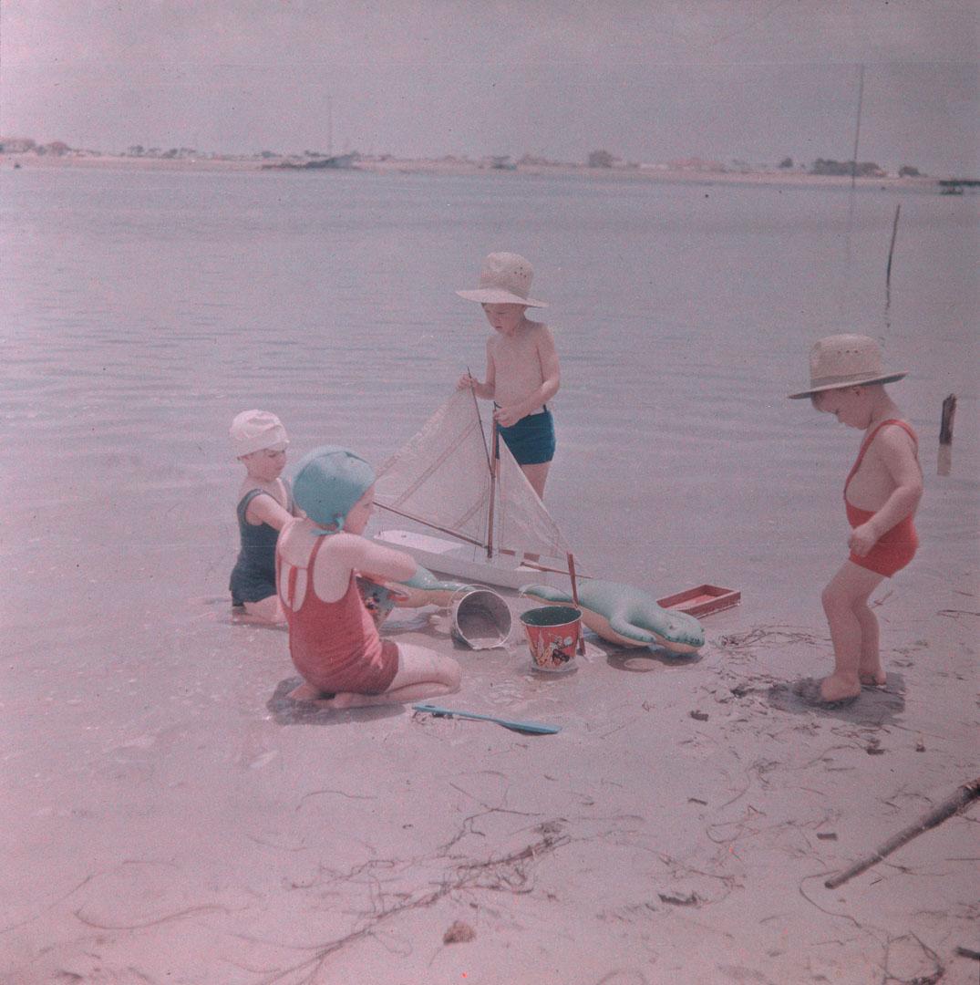 Artwork (Rosemary and three other children playing with a toy boat) this artwork made of Cellulose acetate Dufay colour transparency (originally in a glass mount), created in 1935-01-01