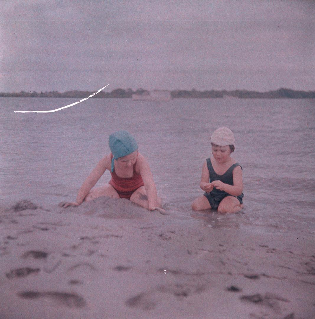 Artwork (Rosemary and unidentified small girl making sand-castles) this artwork made of Cellulose acetate Dufay colour transparency (originally in a glass mount), created in 1935-01-01