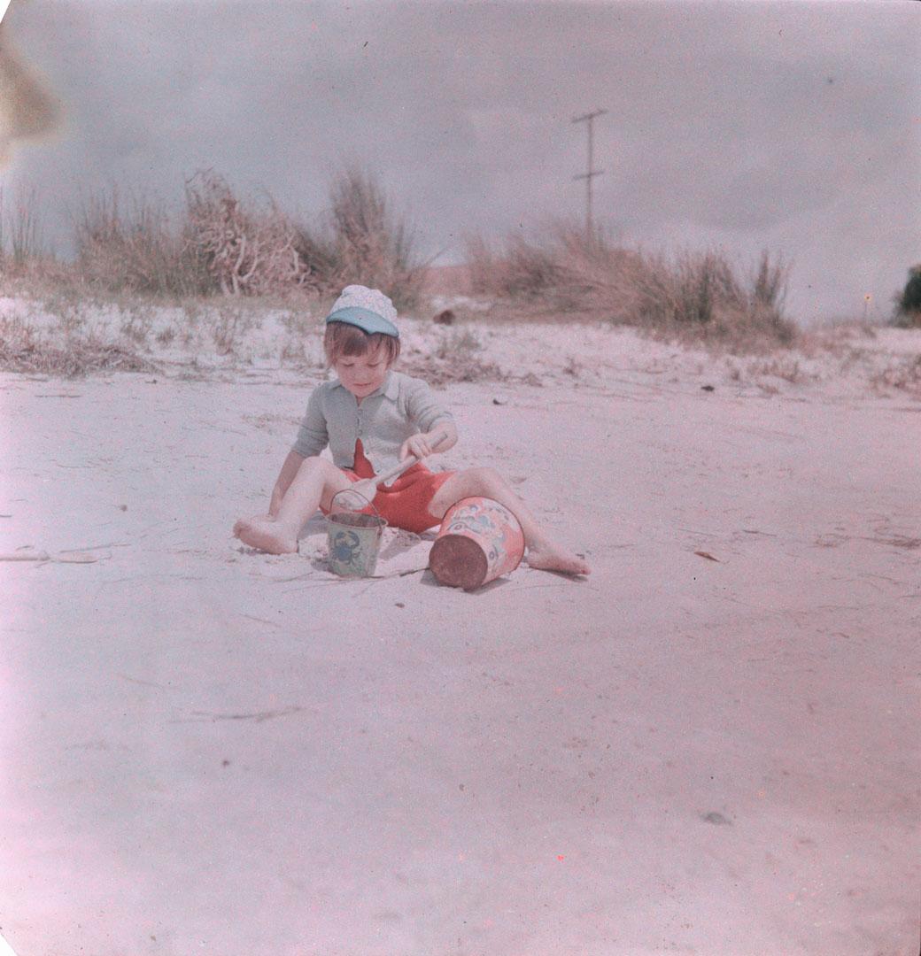 Artwork (Unidentified small girl with spade and sand buckets) this artwork made of Cellulose acetate Dufay colour transparency (originally in a glass mount), created in 1935-01-01