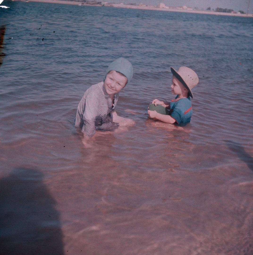 Artwork (Rosemary and unidentified small boy in shallow water) this artwork made of Cellulose acetate Dufay colour transparency (originally in a glass mount), created in 1935-01-01