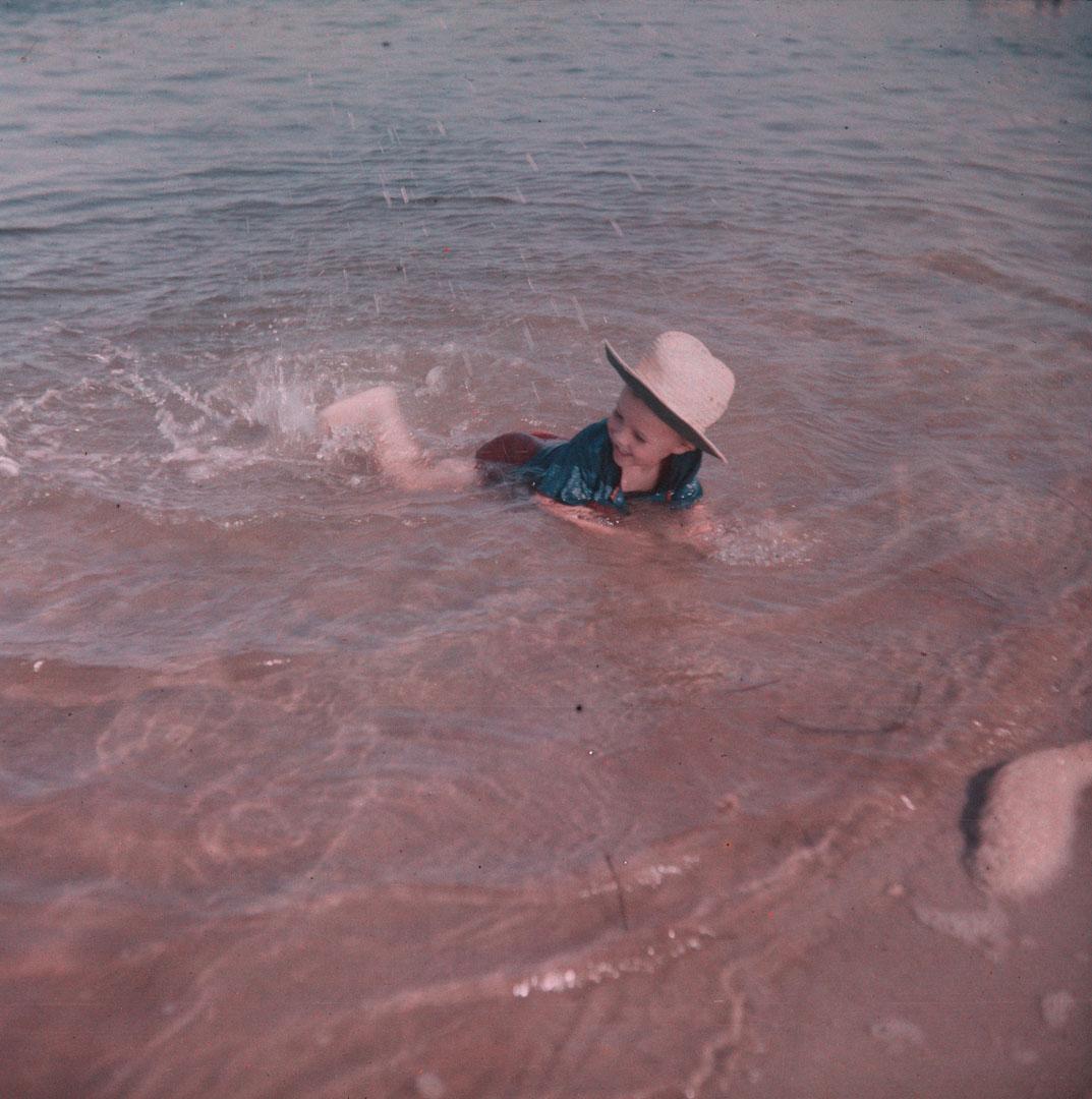 Artwork (Unidentified small boy kicking in water) this artwork made of Cellulose acetate Dufay colour transparency (originally in a glass mount), created in 1935-01-01