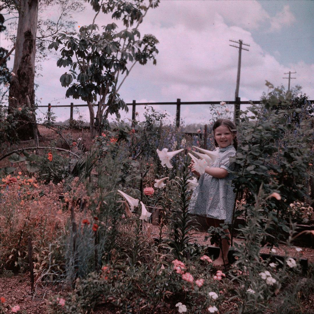 Artwork (Rosemary at 'Pen-y-bryn', standing near flower-beds) this artwork made of Cellulose acetate Dufay colour transparency (originally in a glass mount), created in 1935-01-01