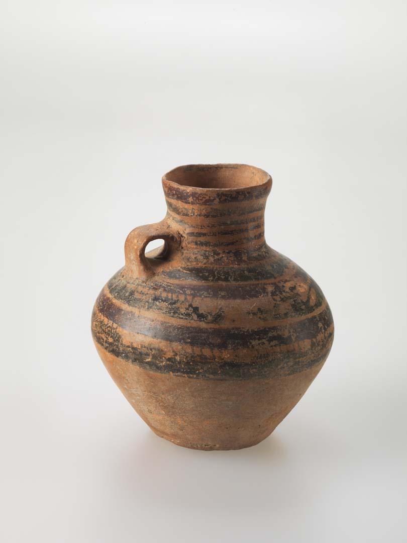 Artwork Urn this artwork made of Earthenware, thrown light brown clay of spherical form with loop handle.  Black and brown glaze decoration, created in 0001-01-01