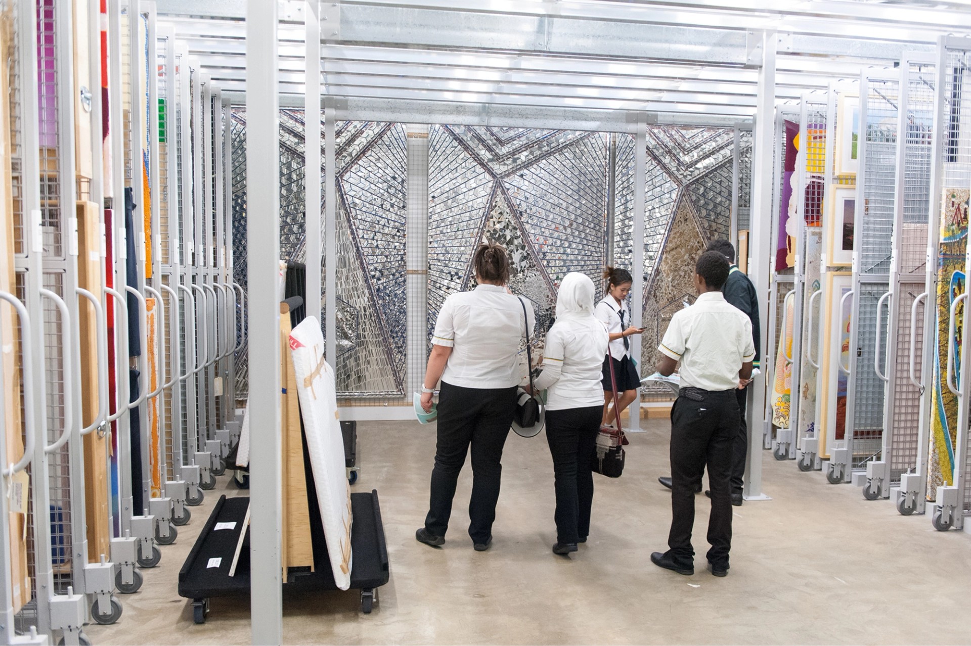 A group of school children visiting a Gallery storage area