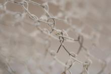 Close up view of rusted, barbed wire with areas in and out of focus
