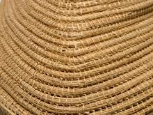 Close up view of a golden burial basket (with handle)