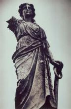 A black and white photograph of a statue of a robed woman