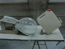 A still from a video, in which a series of industrial and household objects appear to domino across a surface.
