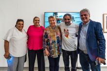 A photograph of Fred Embrey's descendants with Michael Aird in a gallery space