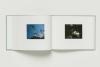 Two page spread of book featuring polaroid photos 
