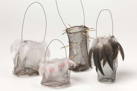 Four string bags woven from wire and feathers.